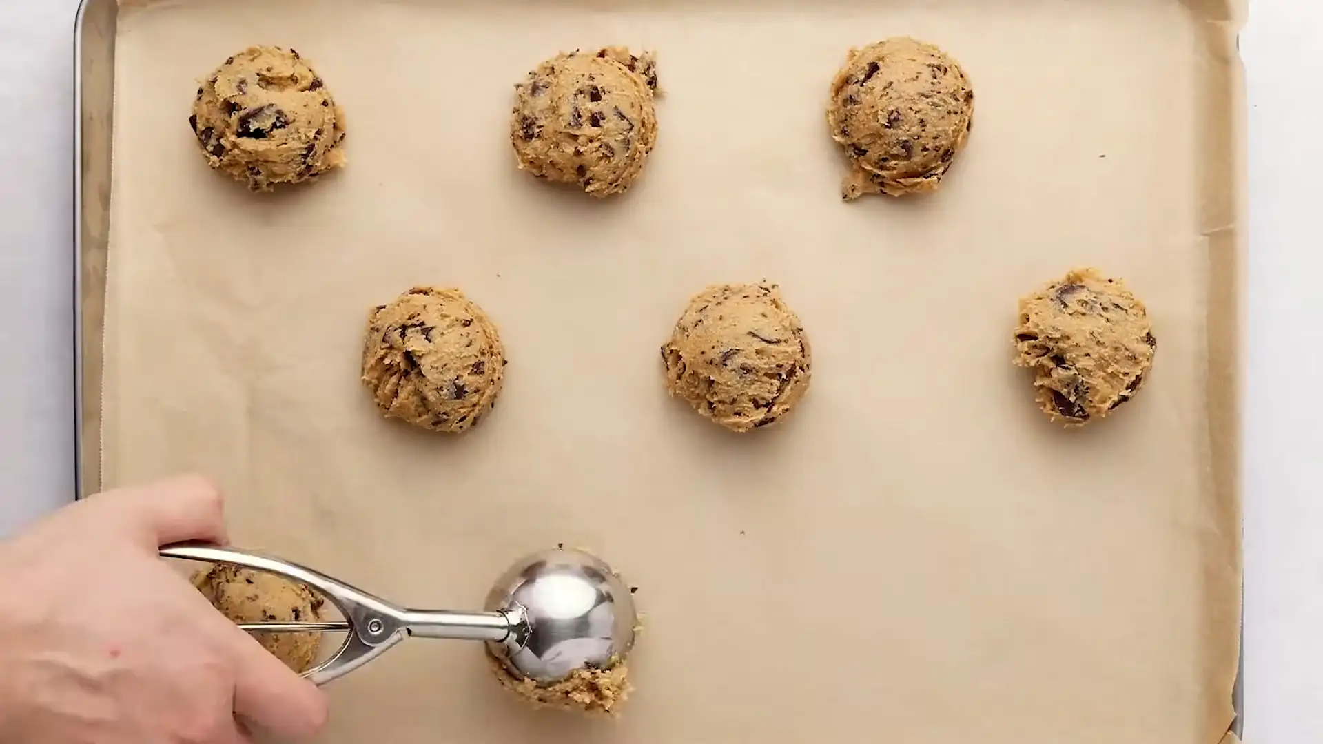 scooping the dough of chocolate chip cookie