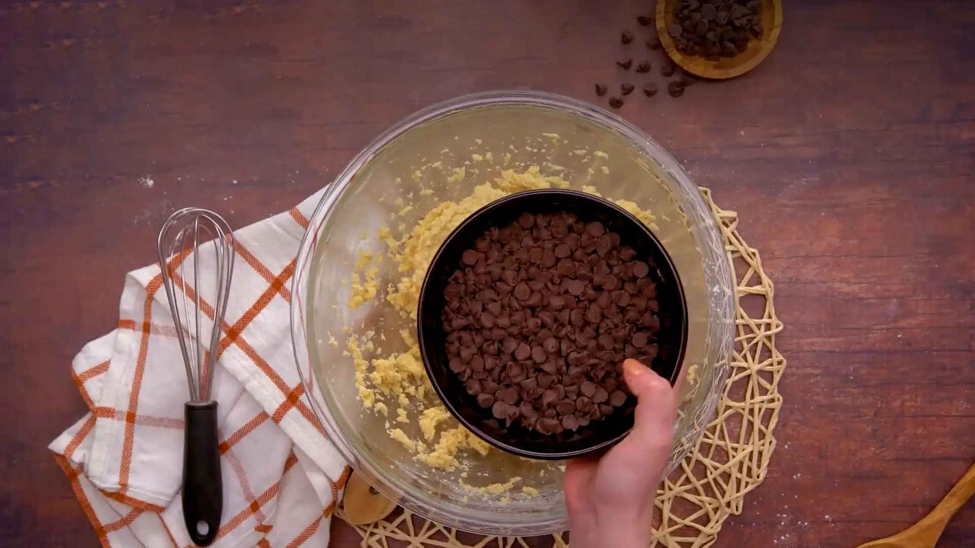 Adding semi-sweet chocolate morsels into Mixture of Toll House Cookie in a Bowl