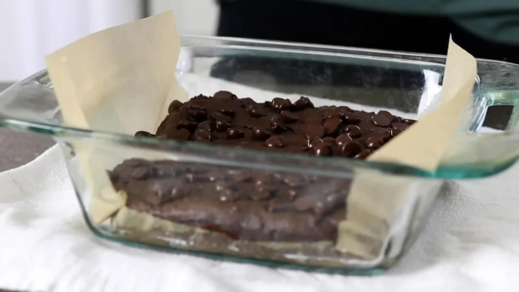 Prepared Brownie batter in a Glass Bowl with parchment paper