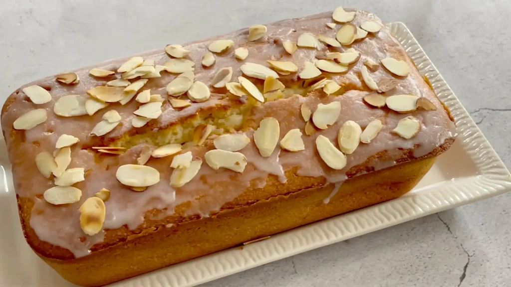 Almond Pound Cake in a Tray with Chopped Almonds and Glaze