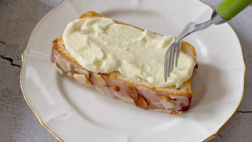 Taking a piece of Almond pound cake from plate by a fork