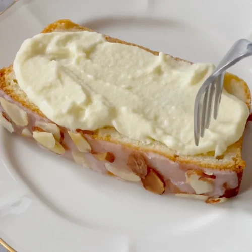 Taking a piece of Almond pound cake from plate by a fork