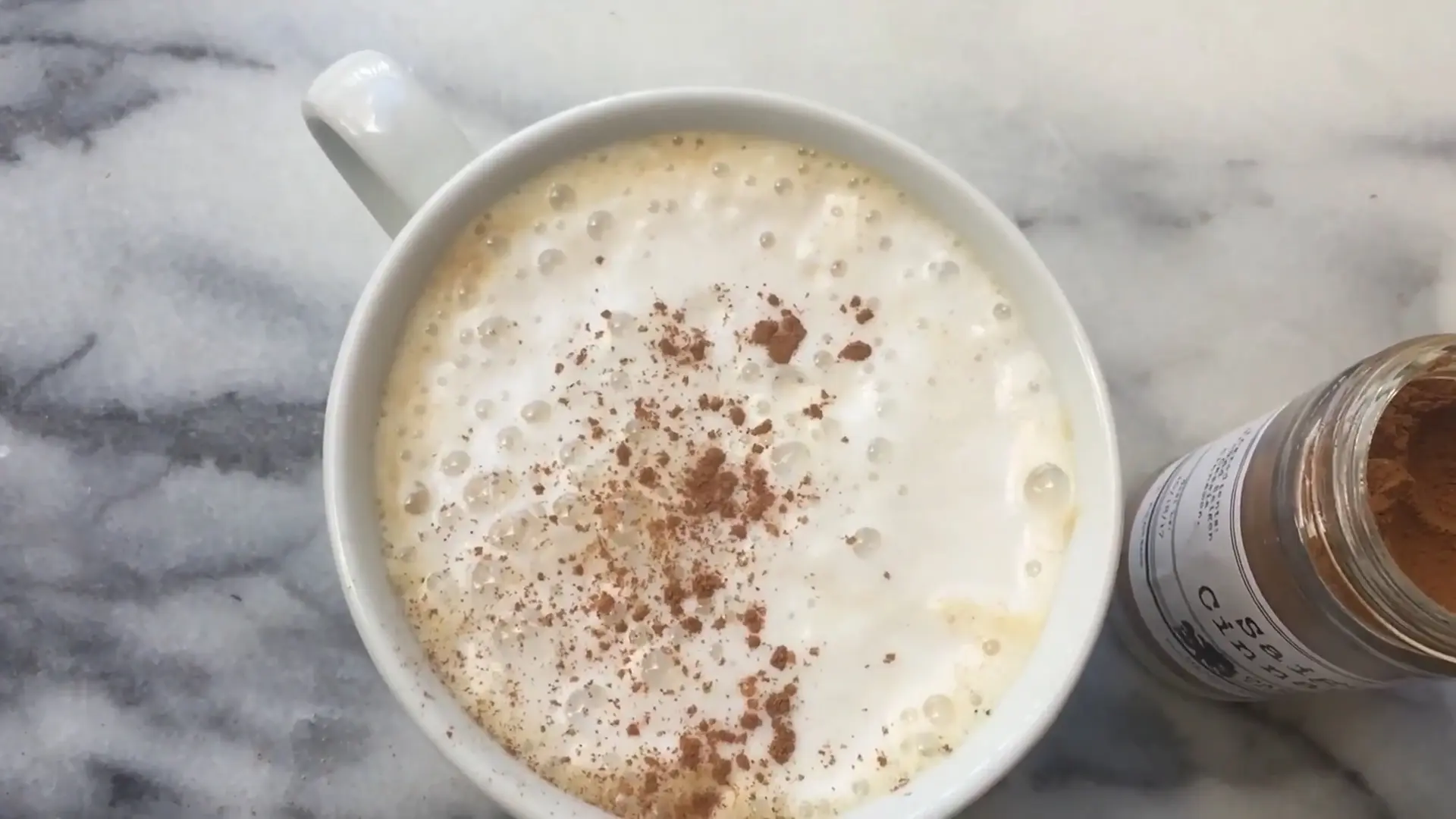 Dirty chai latte in a cup with Cinnamon topping