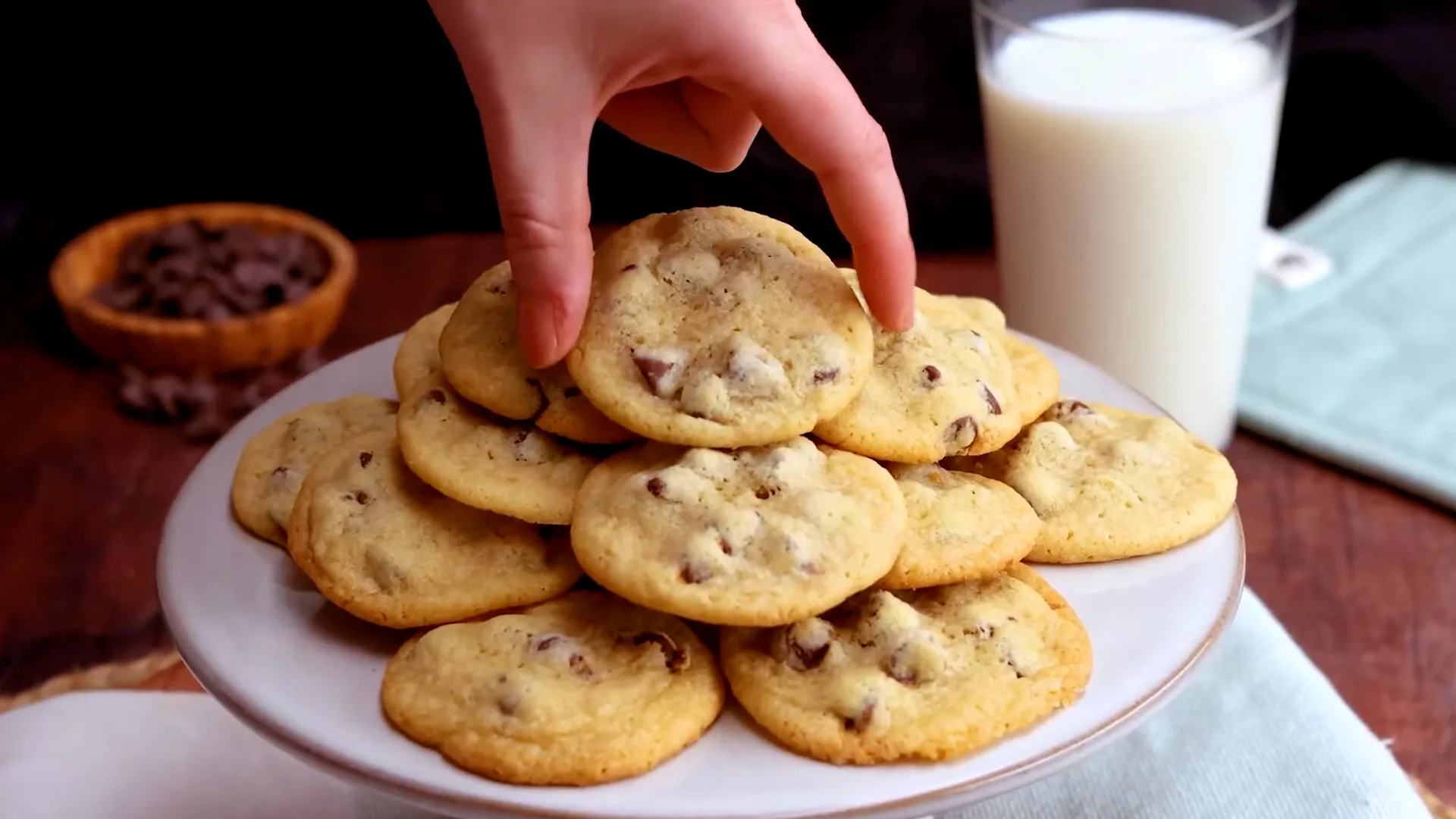 Nestle Toll House Cookies placed in a plate and glass full of milk  