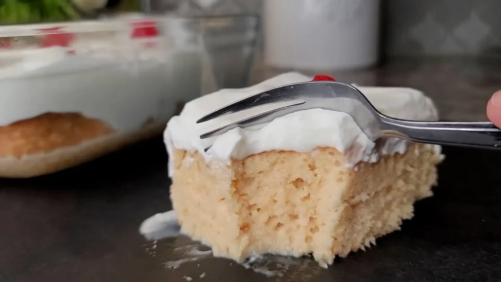 Taking a piece of Tres leches Cake with spoon