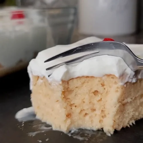 Taking a piece of Tres leches Cake with spoon