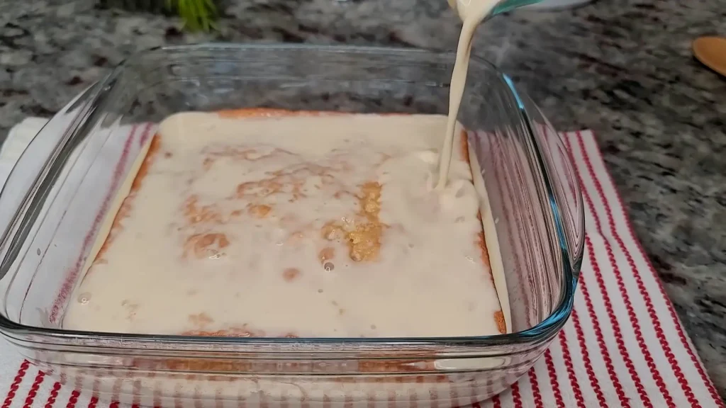 drizzling the milk mixture over the cake