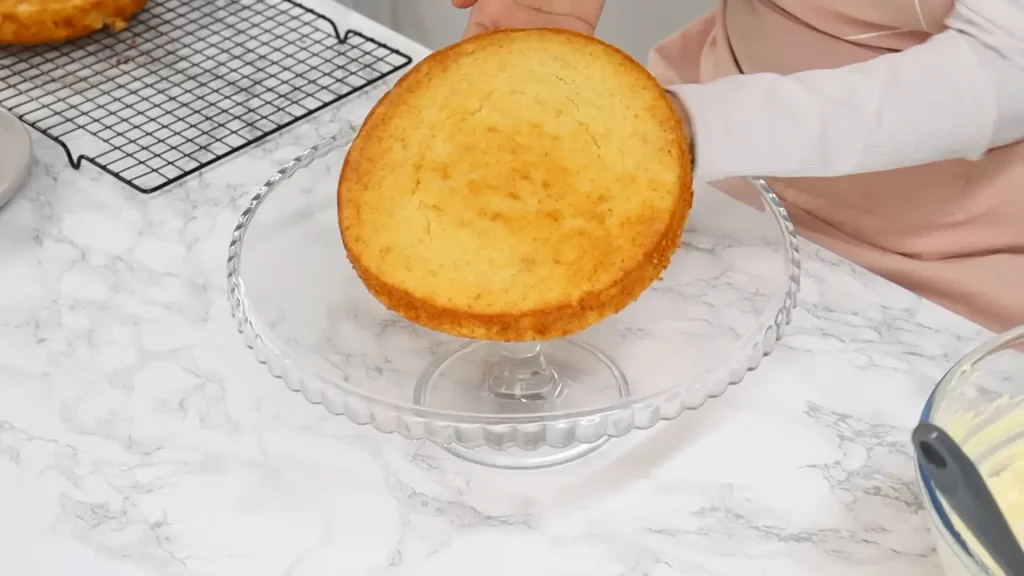 Placing cake on a stand to trim