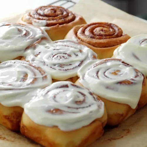 Cinnamon Rolls in a dish with cream topping